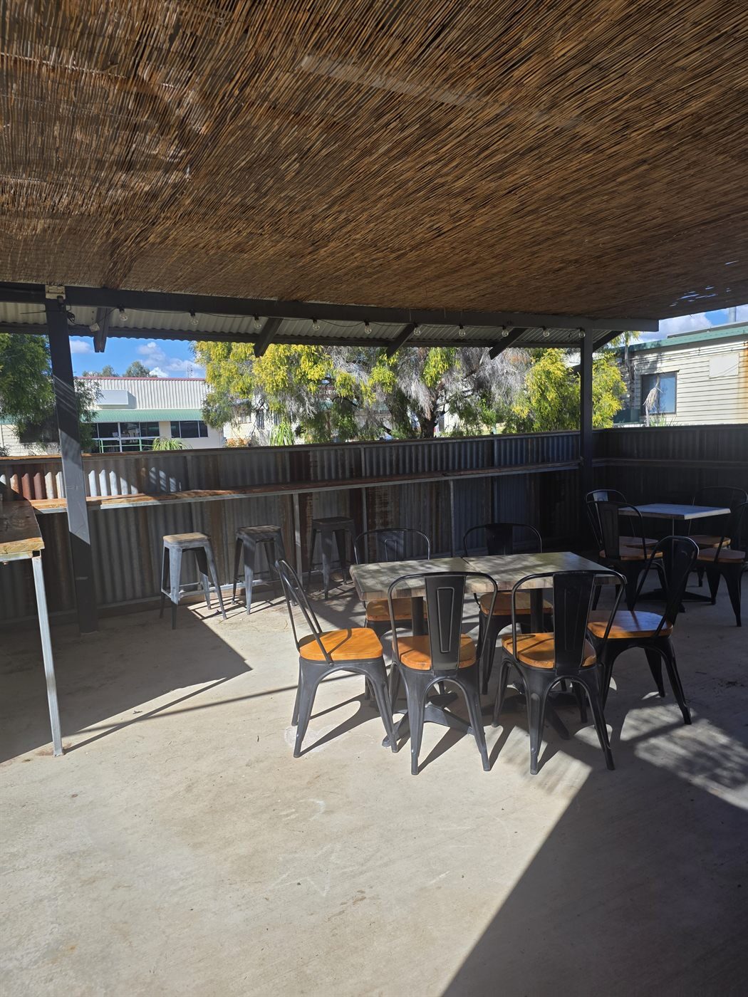 Outdoor seating with metal chairs and timber tables